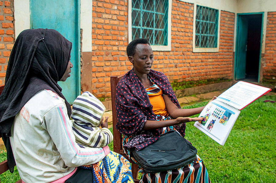 Imelde (R), a health worker in Burundi teaches a patient about the importance of nutrition. Photo: WFP/Aurore Ishimwe